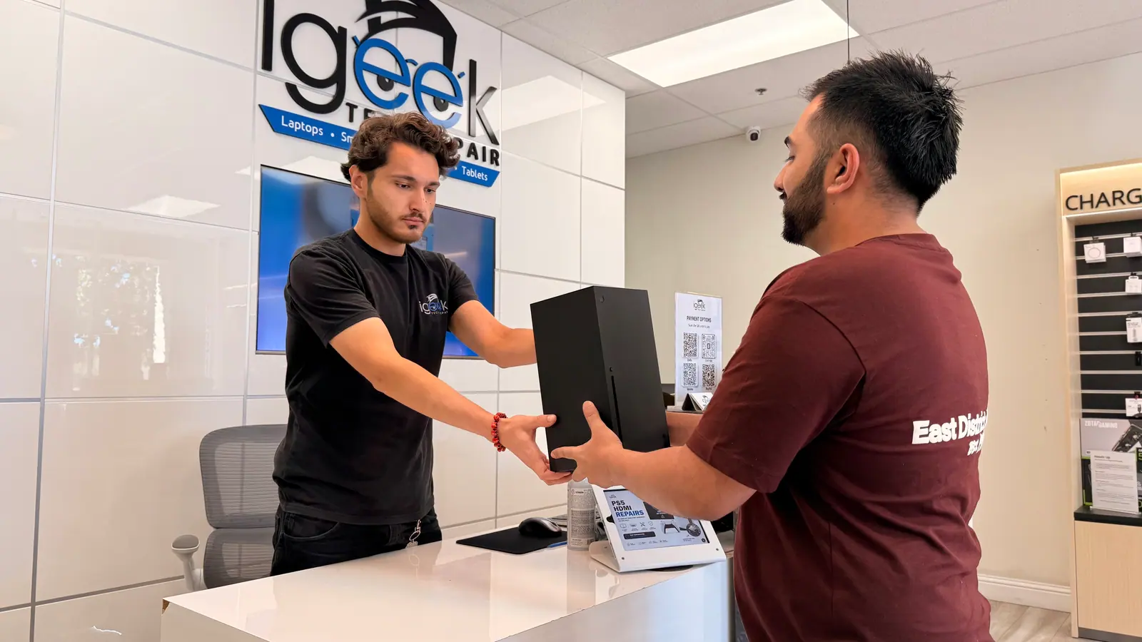 Customer dropping off a desktop tower at the iGeek front counter