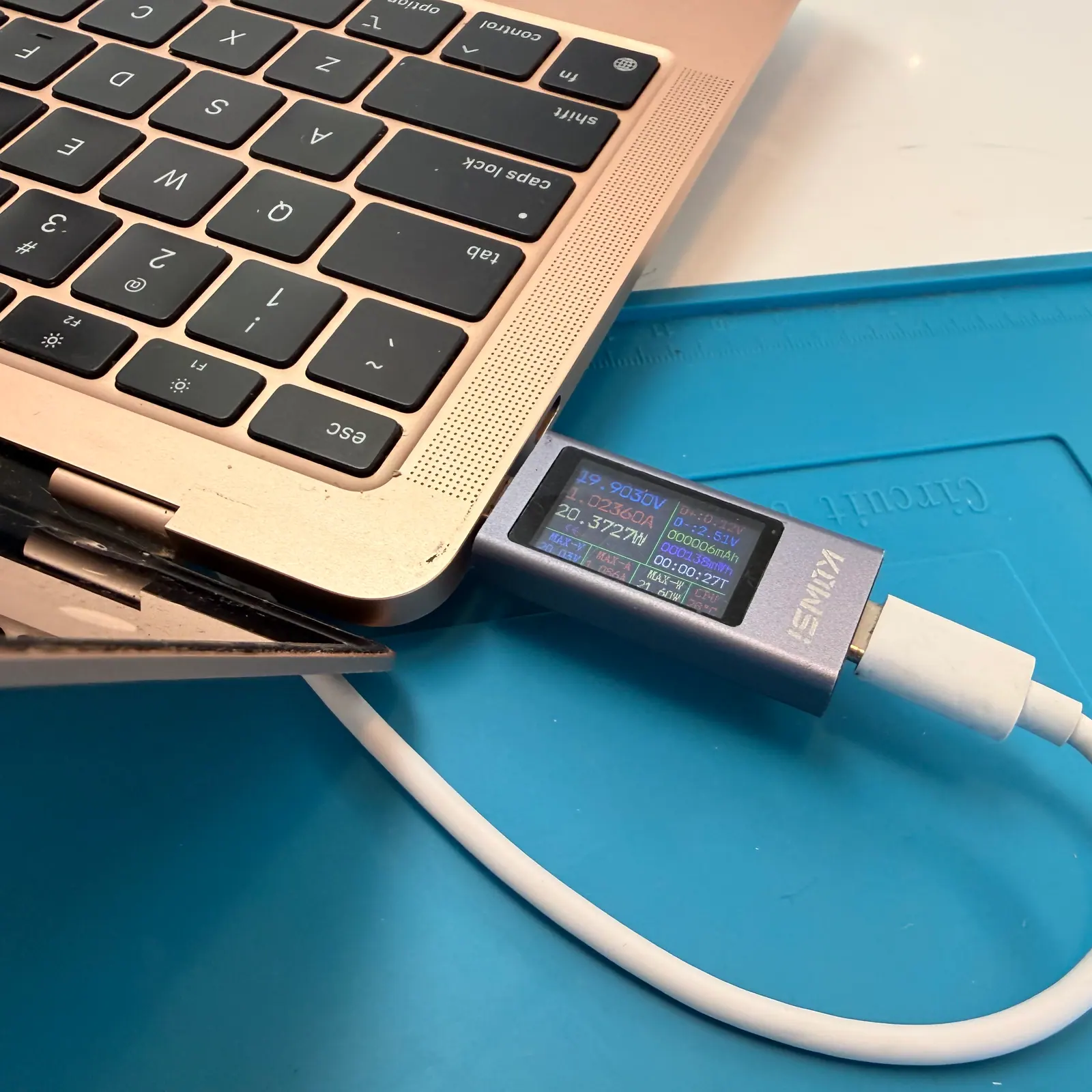 USB-C power meter plugged into a MacBook to test charging
